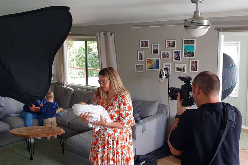 Redlands photographer, Soapbox Creative directing a mum and baby during a newborn photography session